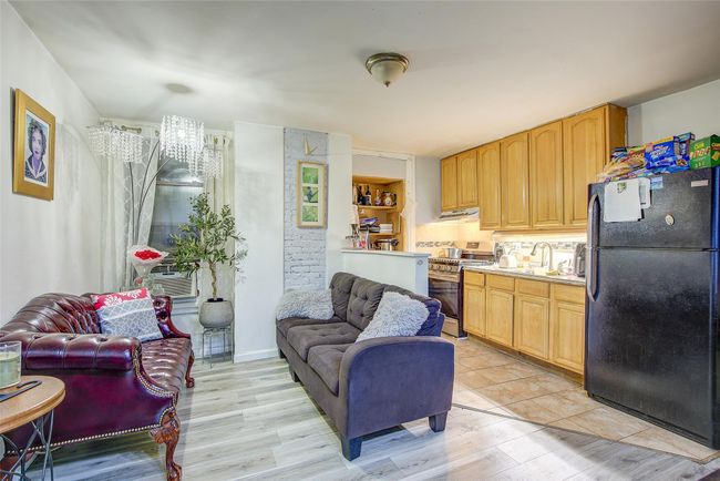 Living room with light wood finished floors and cooling unit | Image 19