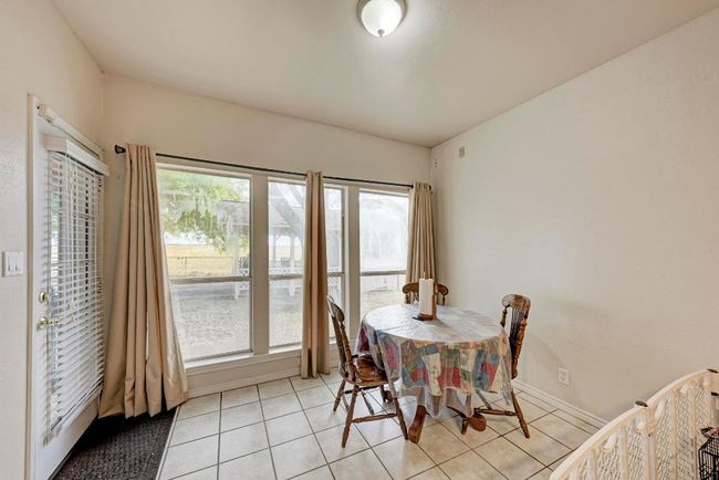 Dining room with light tile patterned flooring | Image 22