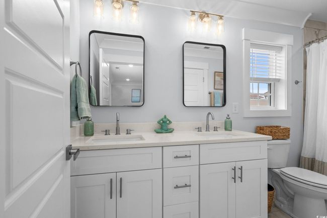 Full bathroom with double vanity and curtained shower | Image 27