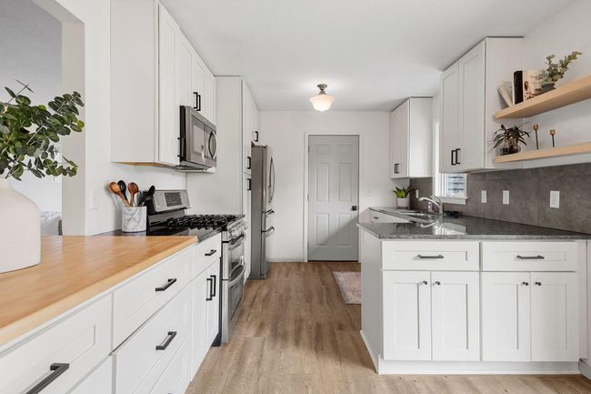 Upgraded white enameled cabinets and stainless appliances | Image 11