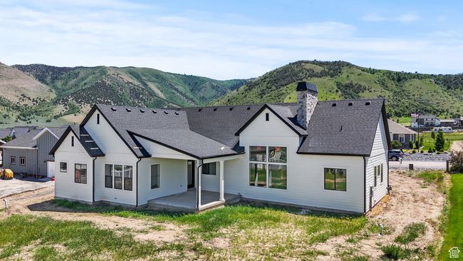 Back of house with a chimney, a mountain view, roof with shingles, and a patio area | Image 30