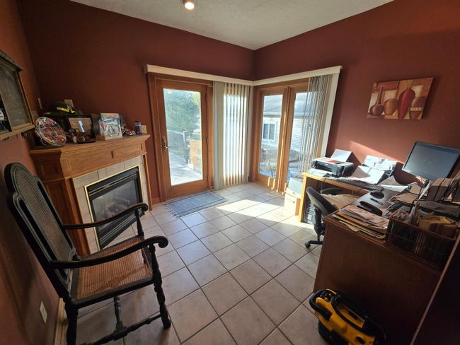 Den/office with patio doors to gorgeous backyard | Image 16