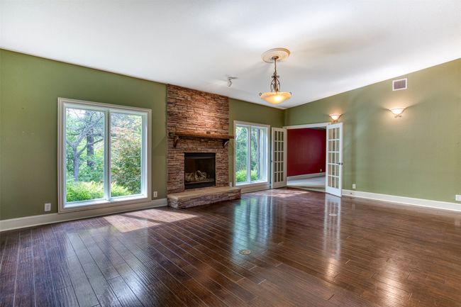 Spacious living room with natural light. | Image 6