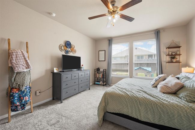 Bedroom featuring light carpet and a ceiling fan | Image 15