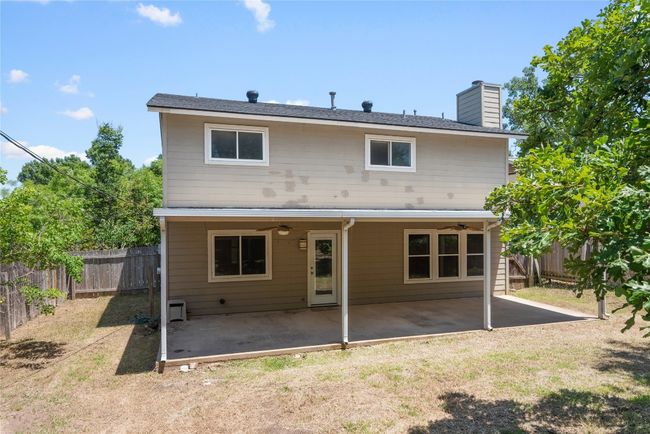 Rear view of property with a ceiling fan, a chimney, and a patio area | Image 22