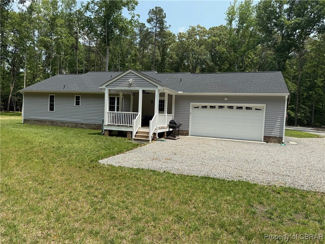 Ranch-style house featuring covered porch, driveway, a garage, a rear yard, enjoy the porch and watch the wildlife. Area for garden, hobby shop, etc. | Image 14