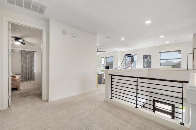 Corridor with light carpet, healthy amount of natural light, and recessed lighting | Image 27