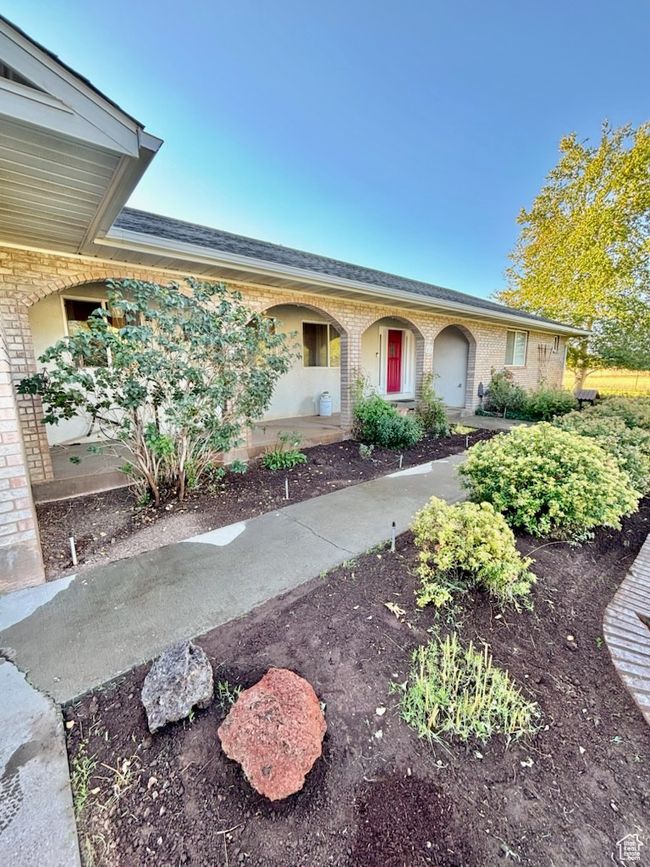 Front of home featuring archways and flower beds | Image 43