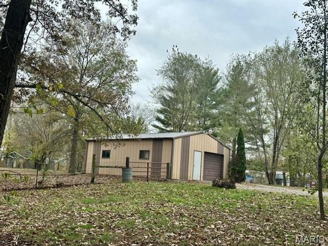 View of outdoor structure with a garage | Image 11