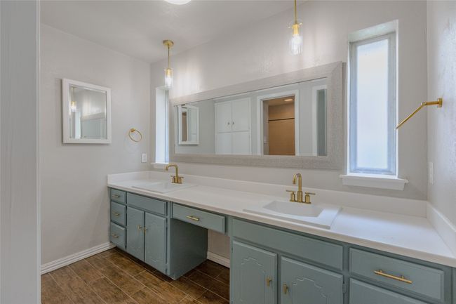 Bathroom featuring double vanity and wood finished floors | Image 13