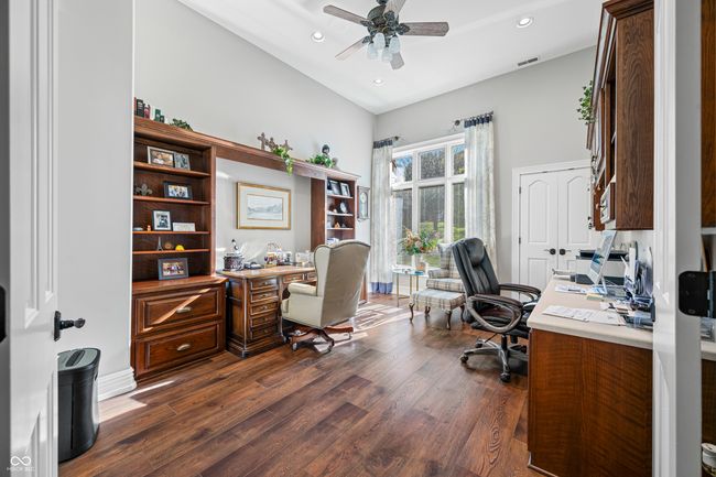 office space featuring recessed lighting, visible vents, a ceiling fan, dark wood-type flooring, and high vaulted ceiling | Image 42