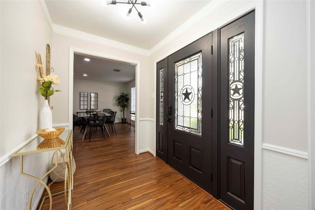 A striking hardwood door opens to a generous foyer space, providing a versatile area that can be personalized to suit your style. | Image 5