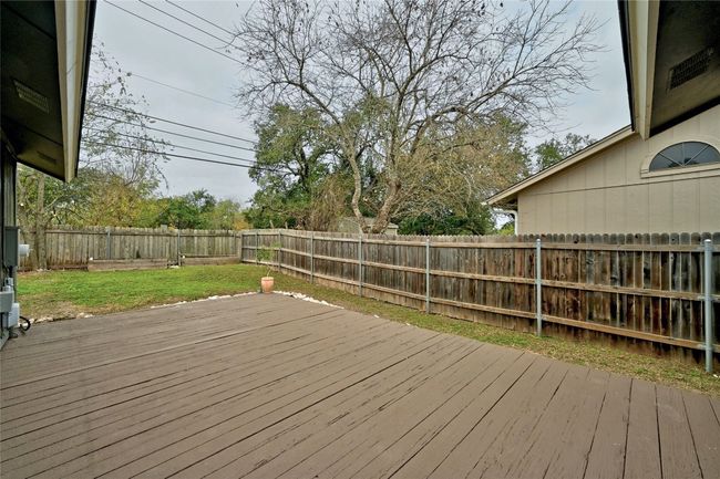 The backyard has a large back deck perfect for your BBQ grill and adding your favorite tables/chairs and chaise lounges to gaze up at the stars. | Image 22
