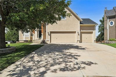 View of front of home with a garage and a front yard | Image 1