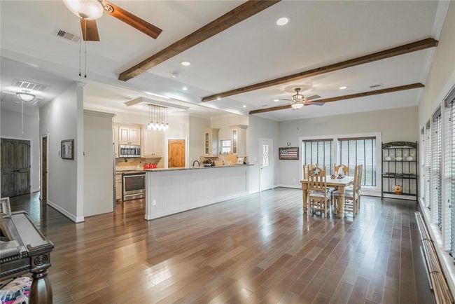 From this view, you can see the kitchen and very large space for the dining room. Large enough to hold your many guests who will be coming out to see "I WILL WALK RANCH. There is enough room here to even put a pool table. | Image 16