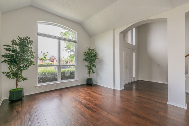 Foyer featuring vaulted ceiling, baseboards, arched walkways, and wood-type flooring | Image 10