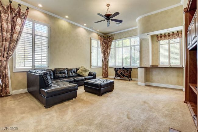 Living area featuring light colored carpet, plenty of natural light, ornamental molding, and baseboards | Image 11
