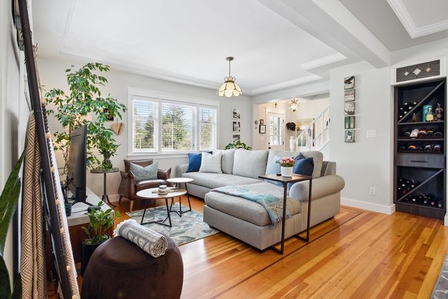 Living area with light wood-type flooring, baseboards, stairs, and crown molding | Image 6