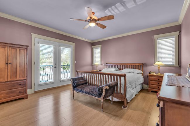 Bedroom with access to outside, ornamental molding, light wood finished floors, ceiling fan, and baseboards | Image 20