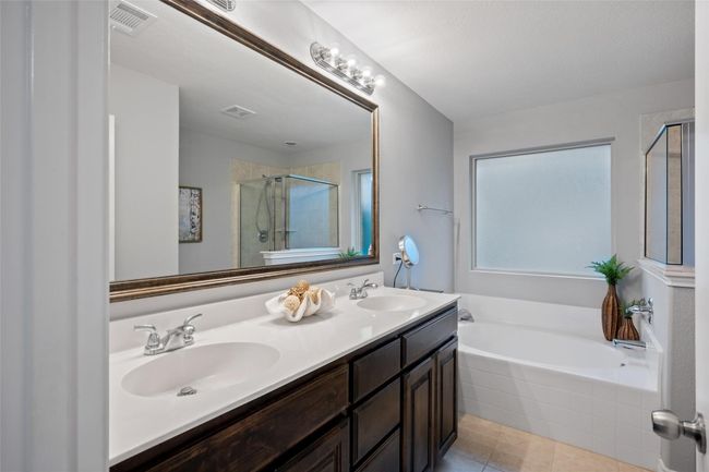 Full bathroom with a shower stall, a garden tub, tile patterned flooring, and double vanity | Image 14