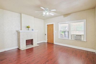 Spare room featuring a textured ceiling, hardwood / wood-style floors, and ceiling fan | Image 2