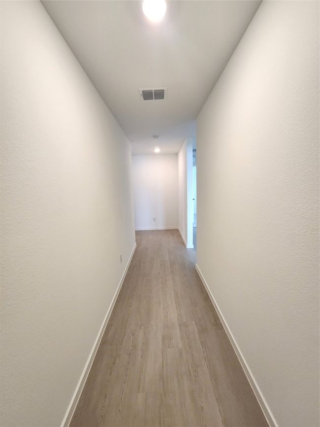Corridor featuring wood finished floors and baseboards | Image 5