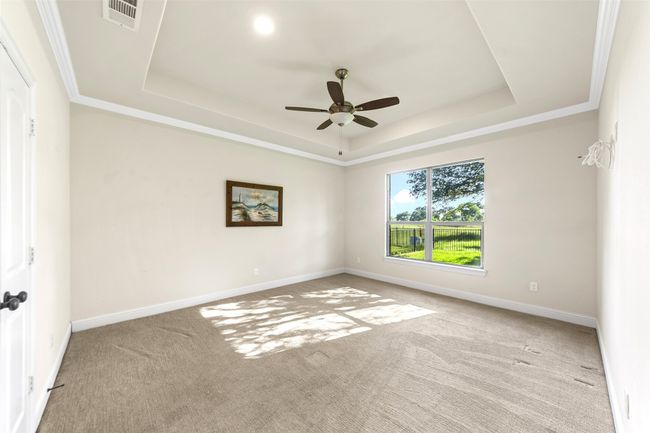Spacious master bedroom retreat with tray ceiling for that custom appeal and value. | Image 22