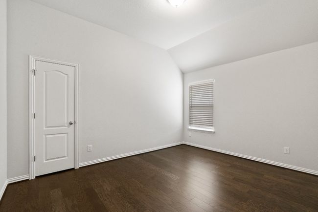 Empty room with vaulted ceiling and dark wood finished floors | Image 19