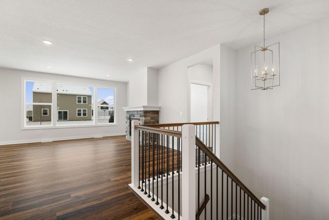 The beautiful great room overlooks the grand staircase, offering a stunning view of the tall ceilings that enhance the sense of space and light. This open design creates a dramatic and inviting atmosphere. | Image 6