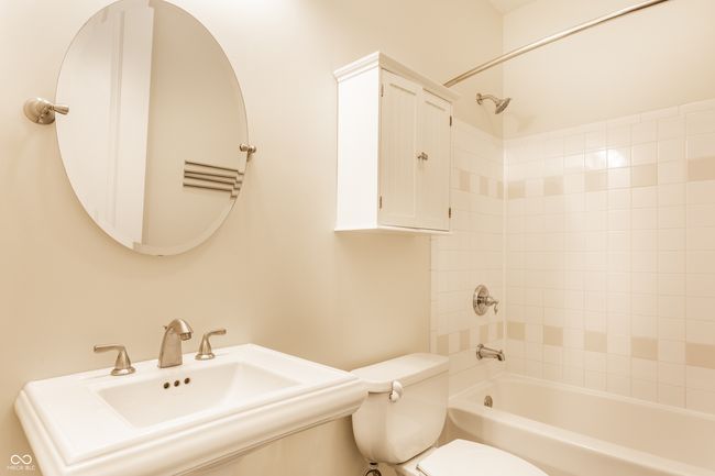 bathroom featuring toilet and shower / bathtub combination | Image 28