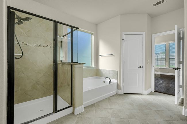 Unwind and soak your worries away in the massive garden tub. | Image 16