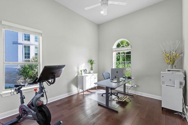 Office / bedroom area featuring baseboards, a ceiling fan, and wood flooring | Image 30