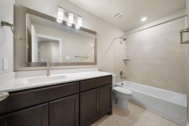 3rd Full bathroom located on the 2nd floor featuring a tub/shower combo and framed mirror. | Image 22