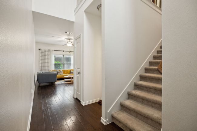 Stairs with a ceiling fan, hardwood / wood-style floors, visible vents, and baseboards | Image 12