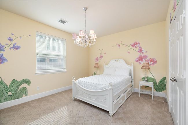 Perfect for guests or family, this spacious secondary suite feels like its own private retreat. The generous bedroom layout offers plenty of room to relax, while the en-suite bathroom with ample storage ensures both convenience and comfort. Whether used as a guest room or a second primary suite, it offers a blend of function and style. | Image 21