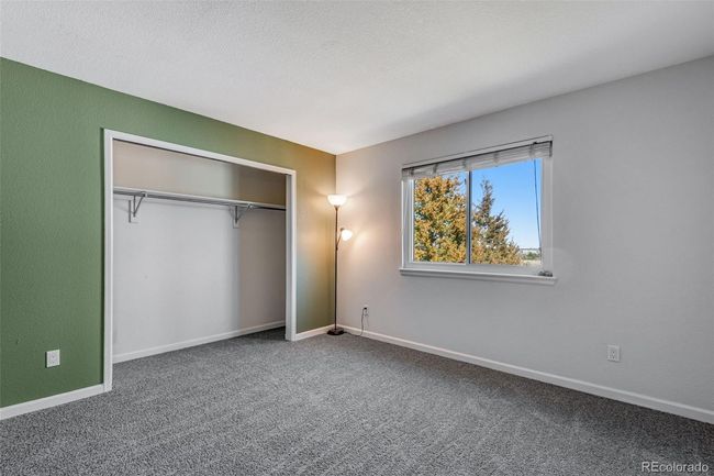 Unfurnished bedroom featuring carpet, a closet, baseboards, and a textured ceiling | Image 22