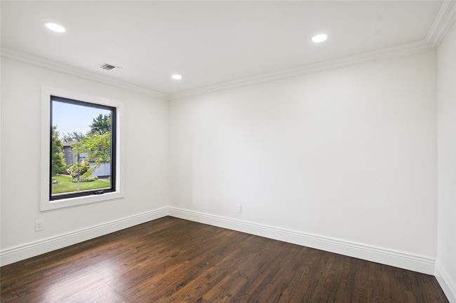 Spare room with dark wood-style flooring, ornamental molding, and recessed lighting | Image 25