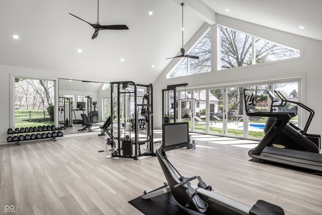 exercise room featuring a wealth of natural light, ceiling fan, and high vaulted ceiling | Image 60
