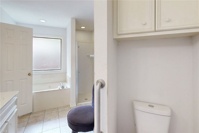 Full bathroom featuring vanity, a bath, tile patterned flooring, toilet, and a shower stall | Image 23