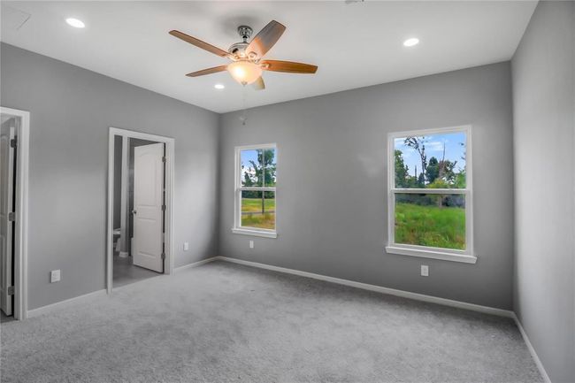 The primary bedroom features neutral colors, 9' ceiling, plenty of natural light and includes a walk-in closet and an en-suite bathroom. | Image 8