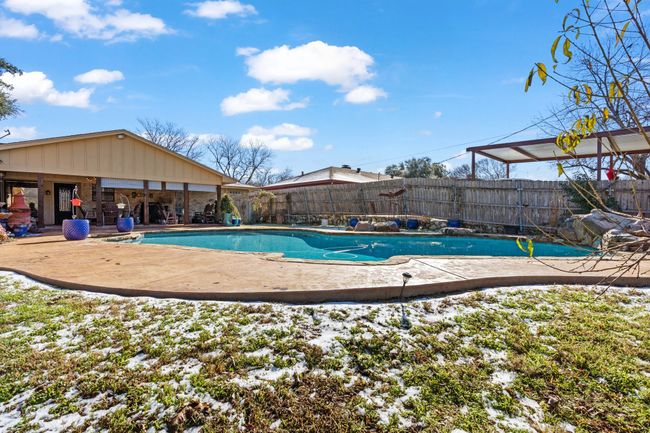 Snow covered pool with a patio | Image 35