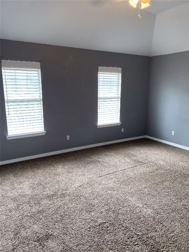Empty room featuring carpet floors, baseboards, and vaulted ceiling | Image 22