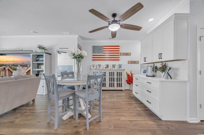 Dining room featuring ceiling fan, ornamental molding, recessed lighting, and dark wood finished floors | Image 12