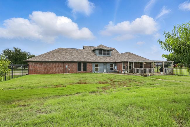 Back of house with brick siding and a shingled roof | Image 33
