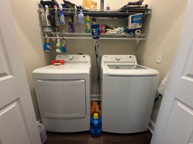Washroom featuring washer and clothes dryer and dark wood finished floors | Image 11