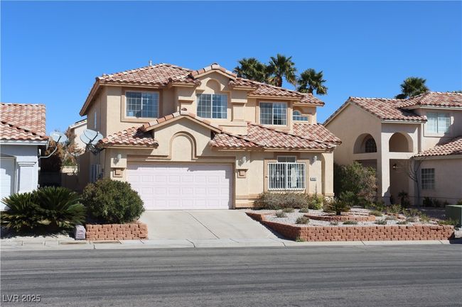 Mediterranean / spanish-style house featuring stucco siding, driveway, and a tile roof | Image 6