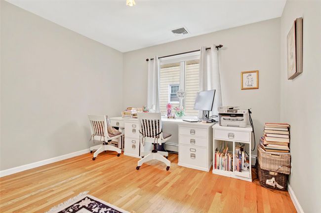 Office with wood finished floors, baseboards, and baseboard heating | Image 35