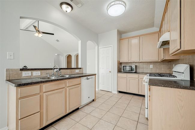 Large kitchen complete with gas appliances and updated fixtures. | Image 11