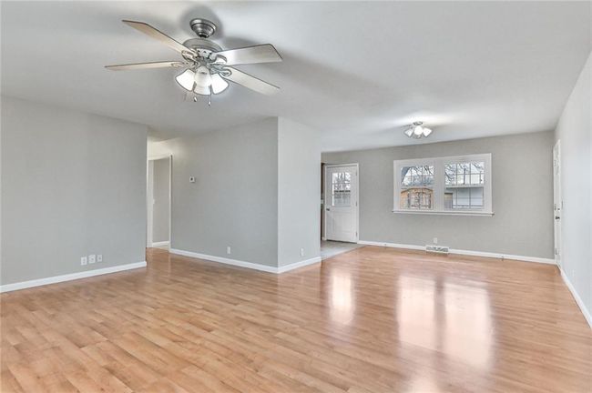 Empty room featuring ceiling fan and light wood-type flooring | Image 9
