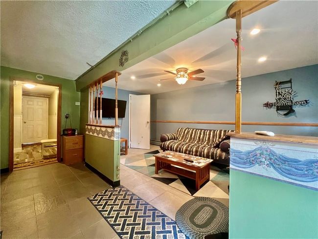 Tiled recreation room featuring ceiling fan and a textured ceiling | Image 18